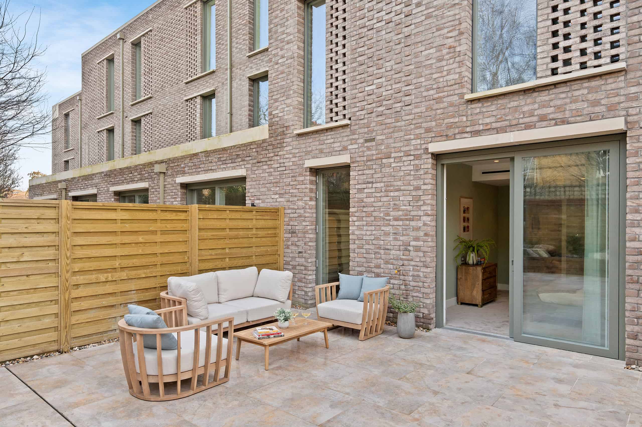 Private garden space with stylish outdoor seating and lush greenery, offering a tranquil retreat in Clapham Quarter.